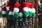 Red white and green colored whips at the farmers market for sale