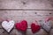 Red, white and grey decorative hearts on aged wooden backgro
