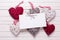 Red, white and grey decorative hearts and empty tag on white