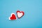 Red and white hearts on a pastel blue background. Minimal creative concept. A symbol of motherly love. Valentine`s Day