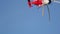 The red-white helicopter flies up and turns in the opposite direction