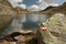 Red and white hiking mark at glacial lake in Aragon Pyrenees