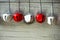 Red and white jingle bells in line on silver background