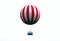 Red and white large balloon levitating with passengers high up in mid air.