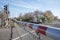 Red and white level crossing railway barrier block a road on countryside in Germany.