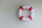 Red and White Lifebuoy Ring Hanging on the Wall at Swimming Pool