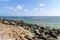 A red and white lighthouse appears in the distant horizon in Warnemunde Rostock Germany