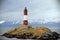 Red and white lighthouse in the Beagle Channel, Ushuaia, Tierra del Fuego, Argentina.