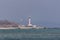 Red and white lighthouse on the Black Sea coast in the town of Chernomorsk