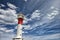 Red and white lighthouse and clouds.