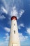 Red and White Lighthouse Extending Towards Blue Cloudy Sky