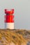 Red white lighthouse on Helgoland Duene island in evening sun