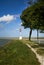 A red and white lighthouse overlooking the sea at the end of the trail