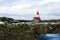 Red And White Lighthouse, Seals On Rocks