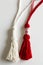 Red and white Martisor, Martenitsa tassel symbolizing springs arrival on white isolated background. Traditional Moldavian,