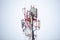 Red-white metal cell tower under the snow