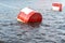 Red and white metal mooring buoys.