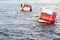 Red and white metal mooring buoys.