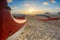 Red and white outrigger canoe on beach