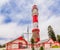 Red white painted beacon, and houses, Swakopmund, German  colonial town, Namibia