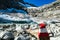 Red white path mark with scenic view on a glacier lake near Hoher Sonnblick in the mountains of High Tauern Alps in Carinthia,