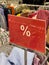 red and white percent sale sign in store mobile photo