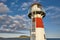 Red and white picturesque lighthouse. Faroe islands, Torshavn harbor