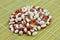 Red and white pointed beans on bamboo mat