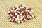 Red and white pointed beans on bamboo mat