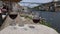 Red, white and Porto wine glasses overlooking tourists at Cais da Ribeira, Porto, Portugal