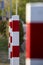 Red white posts in a row, focus on the second post