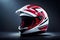 red and white racer helmet isolated on dark background