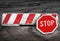 Red white road barrier and stop road sign