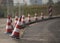 Red and white roadblocks next to each other during daytime