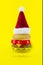 Red-white Santa hat on Plastic hamburger christmass tree on yellow background. Christmas burgers New year fast food