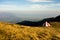 Red and white shelter on a mountain ridge