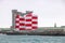 Red white silo tanks. Port buildings and hangars