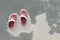 Red and white slippers on cement floor.