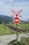Red and white stop sign for people at railway crossing
