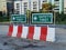 Red and White Striped Barricades with Safety First Labels on Street