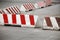 Red and white striped concrete road barriers
