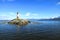 Red and white striped Les Eclaireurs lighthouse on a rocky islands of Beagle channel, Ushuaia, Tierra del Fuego, Argentina