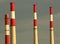 Red and white striped smokestacks seen during sunset