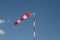 Red-white striped windsock on a pole