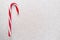 Red and White Stripped Candy Canes on a Glitter Background