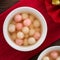 Red and white tangyuan with syrup soup