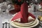 Red and white theme wedding breakfast dining table setting close up.