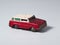 a red and white tin toy van that looks dusty, rusty and shabby