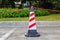 Red-white traffic cone and chain on street