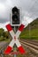 Red and white traffic sign for railroad crossing with a switched